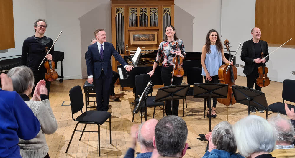 Broad smiles on the performers' faces as they receive rapturous applause at the end of the concert